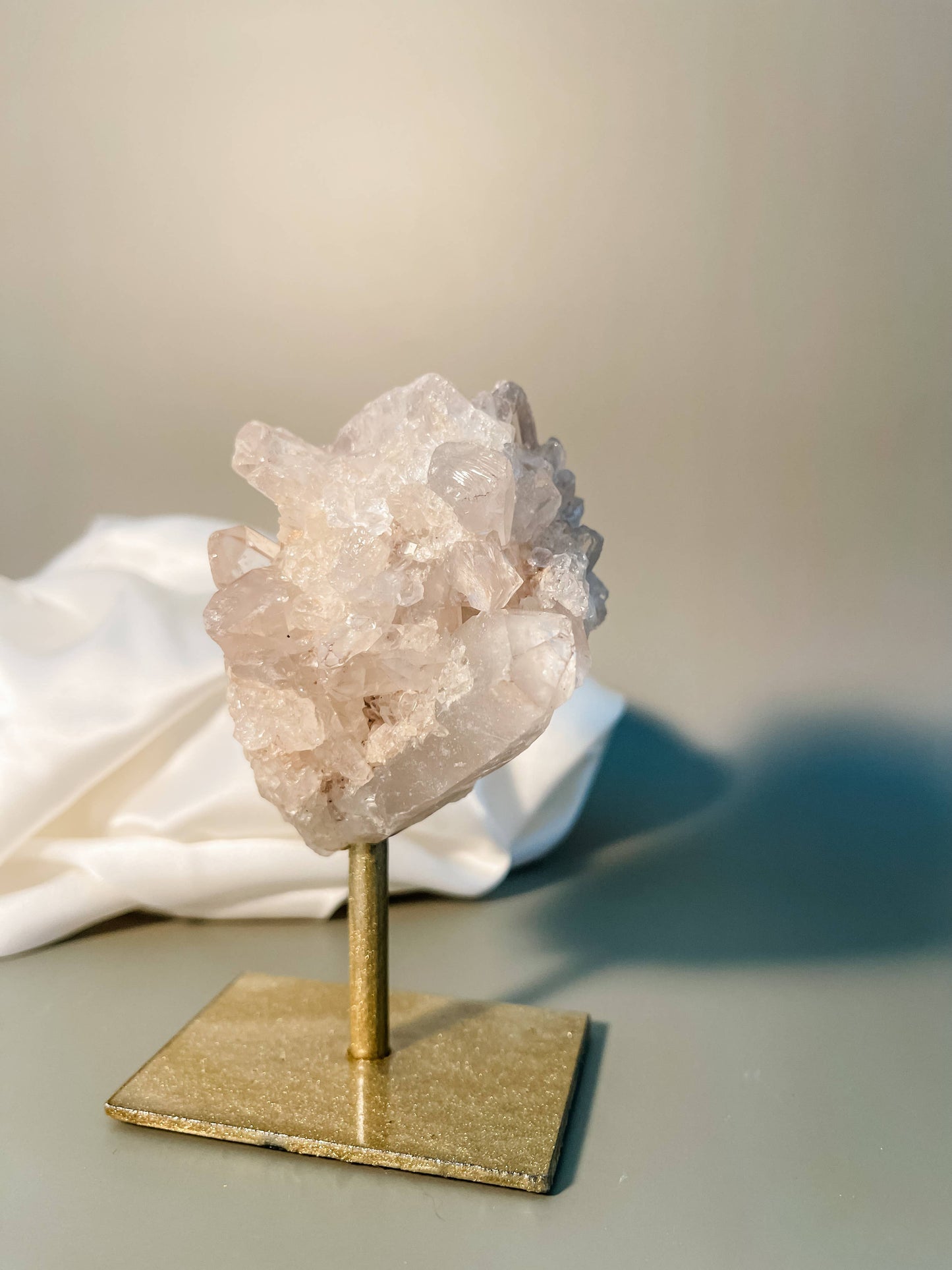 Clear quartz cluster on gold stand